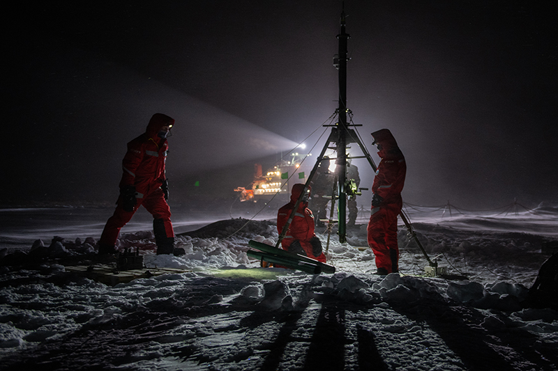 In December 2019, MOSAiC personnel set up a 30-meter tower on ice with the research icebreaker R/V Polarstern in the distance. Photo is by Esther Horvath, Alfred Wegener Institute.