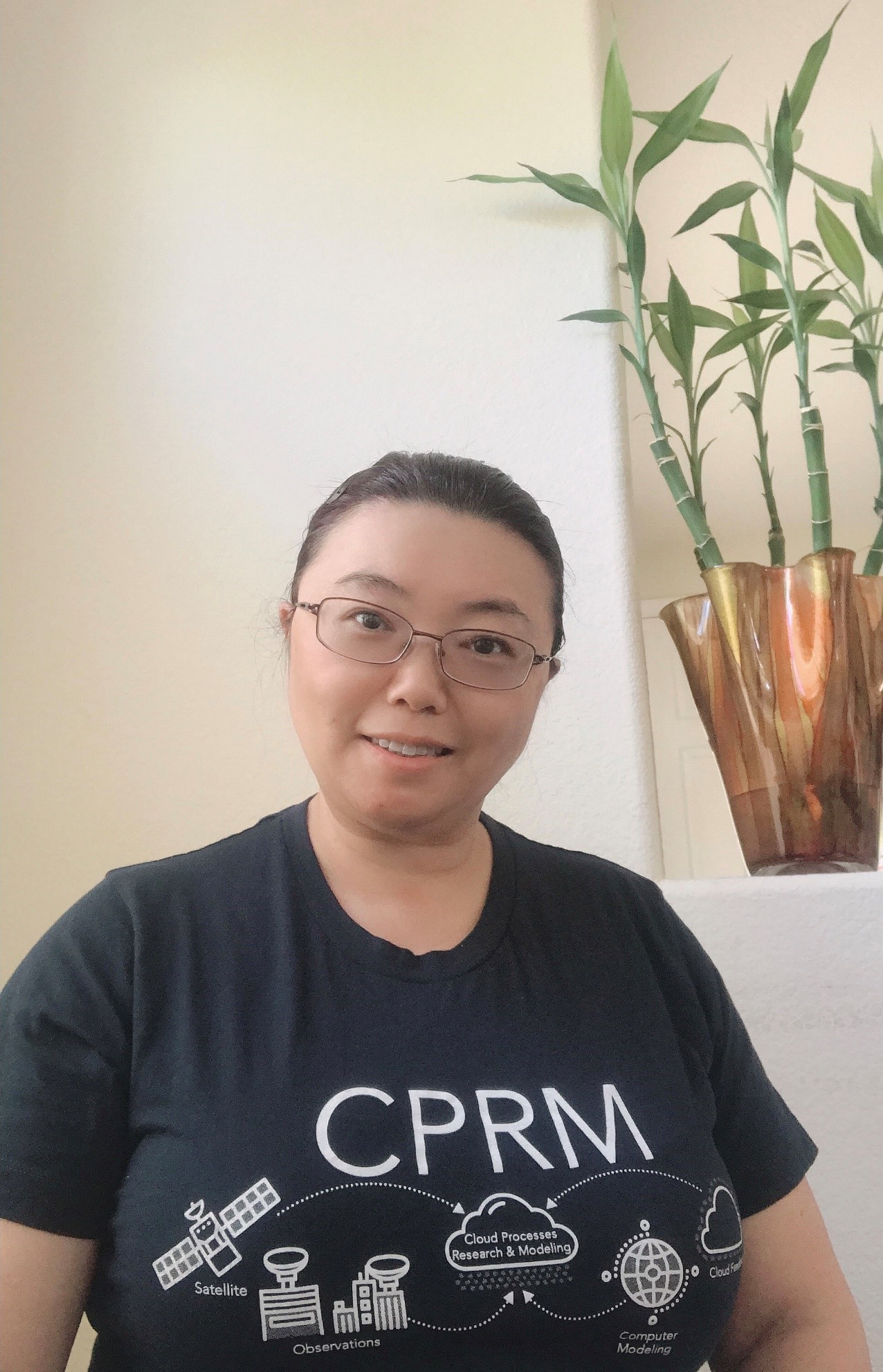 Zhang pauses during work in her home office, modeling a T-shirt made for the Cloud Processes Research and Modeling (CPRM) group at Lawrence Livermore National Laboratory. 