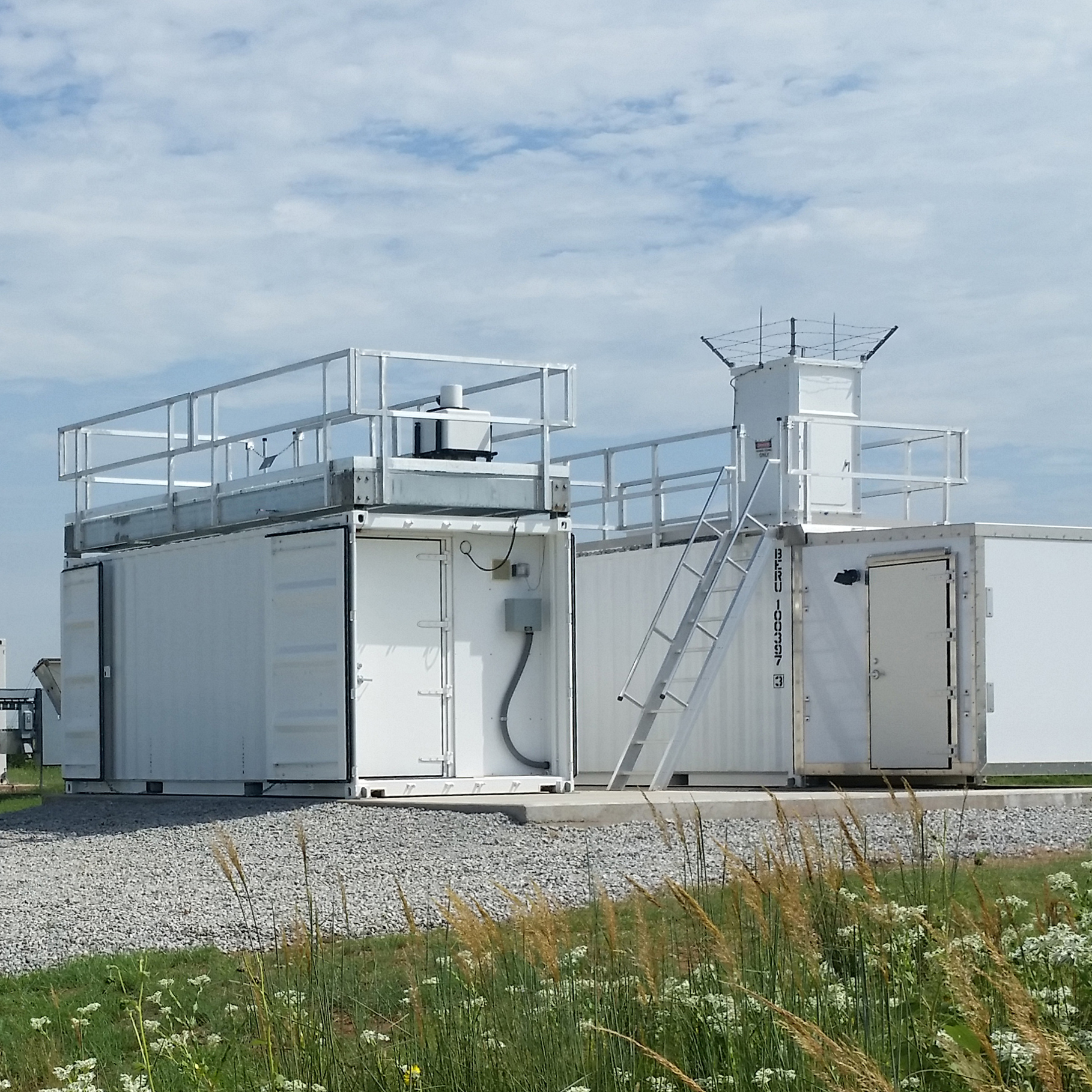 At ARM’s Southern Great Plains atmospheric observatory, the Doppler lidar, atop the left container, measures profiles of horizontal wind and turbulent motions in the boundary layer. The Raman lidar, to the right, delivers profiles of water vapor. A joint meeting breakout session provided updates on these and other ARM lidar systems.