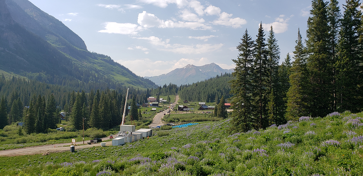 On June 22, 2021, ARM Mobile Facility site construction takes place at Gothic Townsite, Colorado, for the upcoming Surface Atmosphere Integrated Field Laboratory (SAIL) campaign. Hazy air conditions reflect fires in the area. 