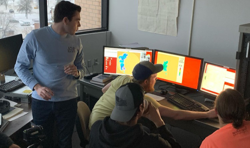 Members of the BLOWN-UNDER radar team synchronize the University of North Dakota’s rooftop C-band radar with signals from the Doppler on Wheels. 