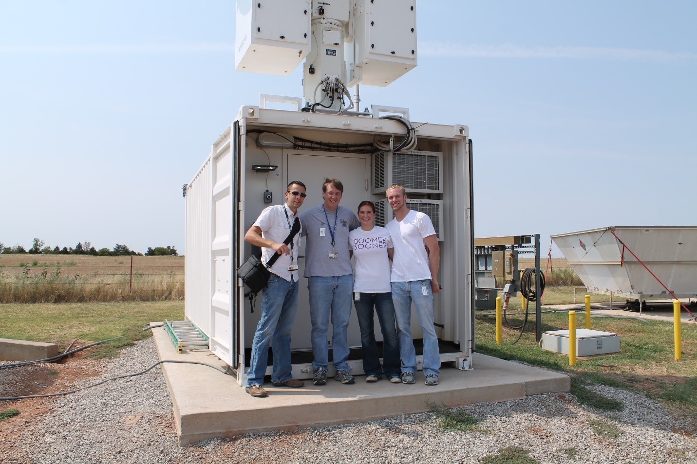 Left to right, Theisen and University of Oklahoma student data-quality analysts Aaron Hardin, Erika Kruse, and John Ragland pose at ARM’s Southern Great Plains atmospheric observatory in 2012.