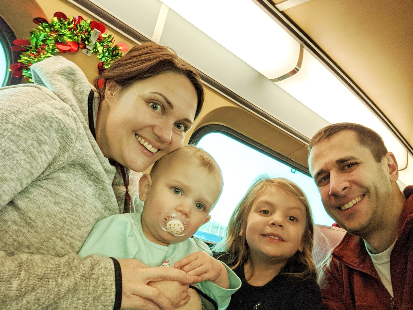 Theisen poses with (from left) his wife Casey and their daughters Maya and Auria.