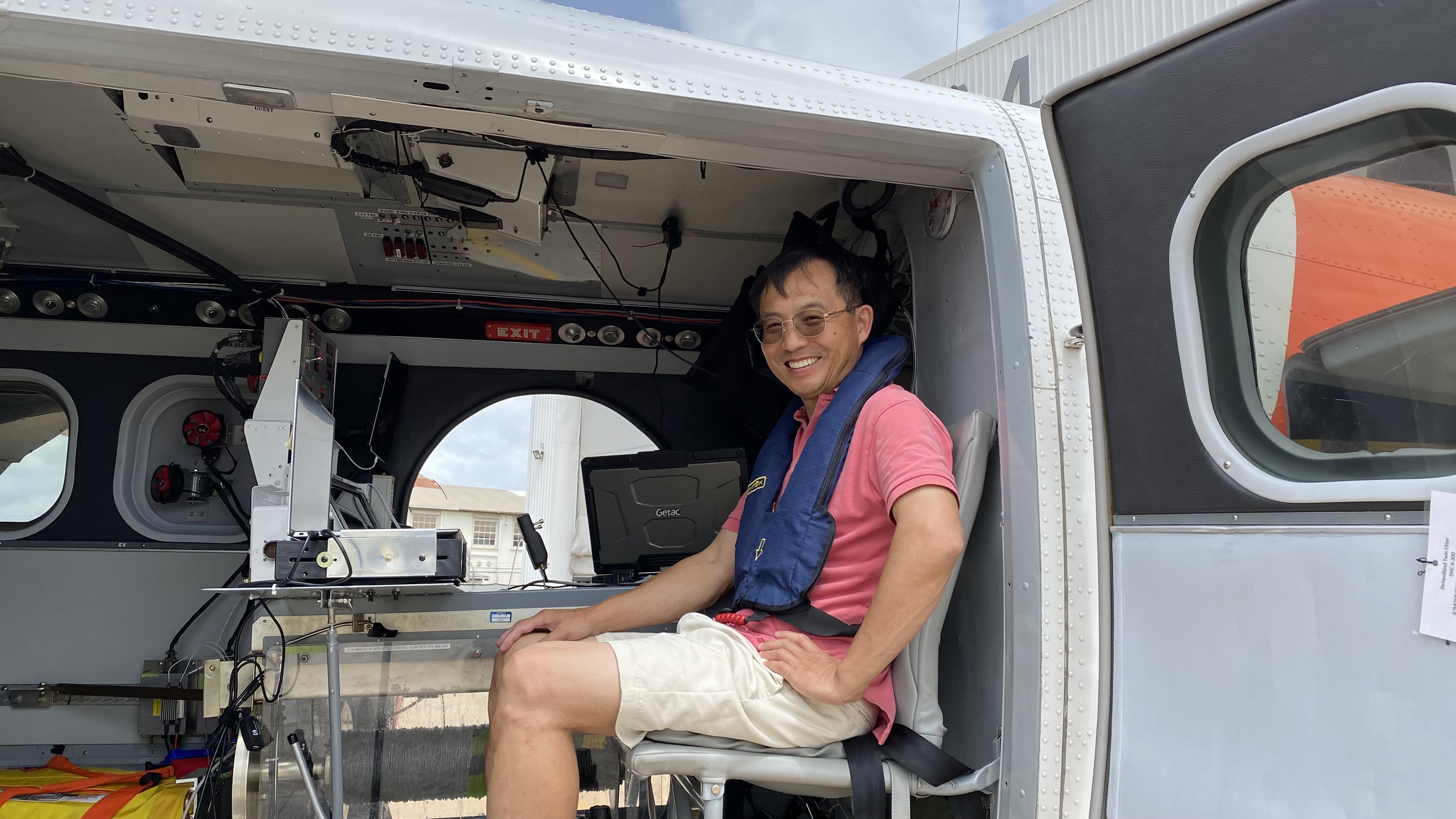 Wang poses in a Twin Otter aircraft in Barbados during the summer of 2023. The mission was to observe tropical planetary boundary layer structures with newly developed Doppler lidars from the Naval Postgraduate School. 