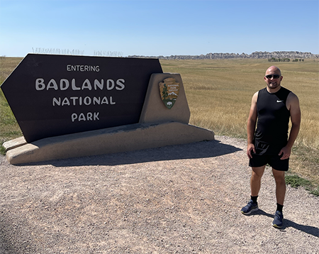 Dzambo, a travel and hiking enthusiast, looks ready in this 2022 photo to take on Badlands National Park in South Dakota. 