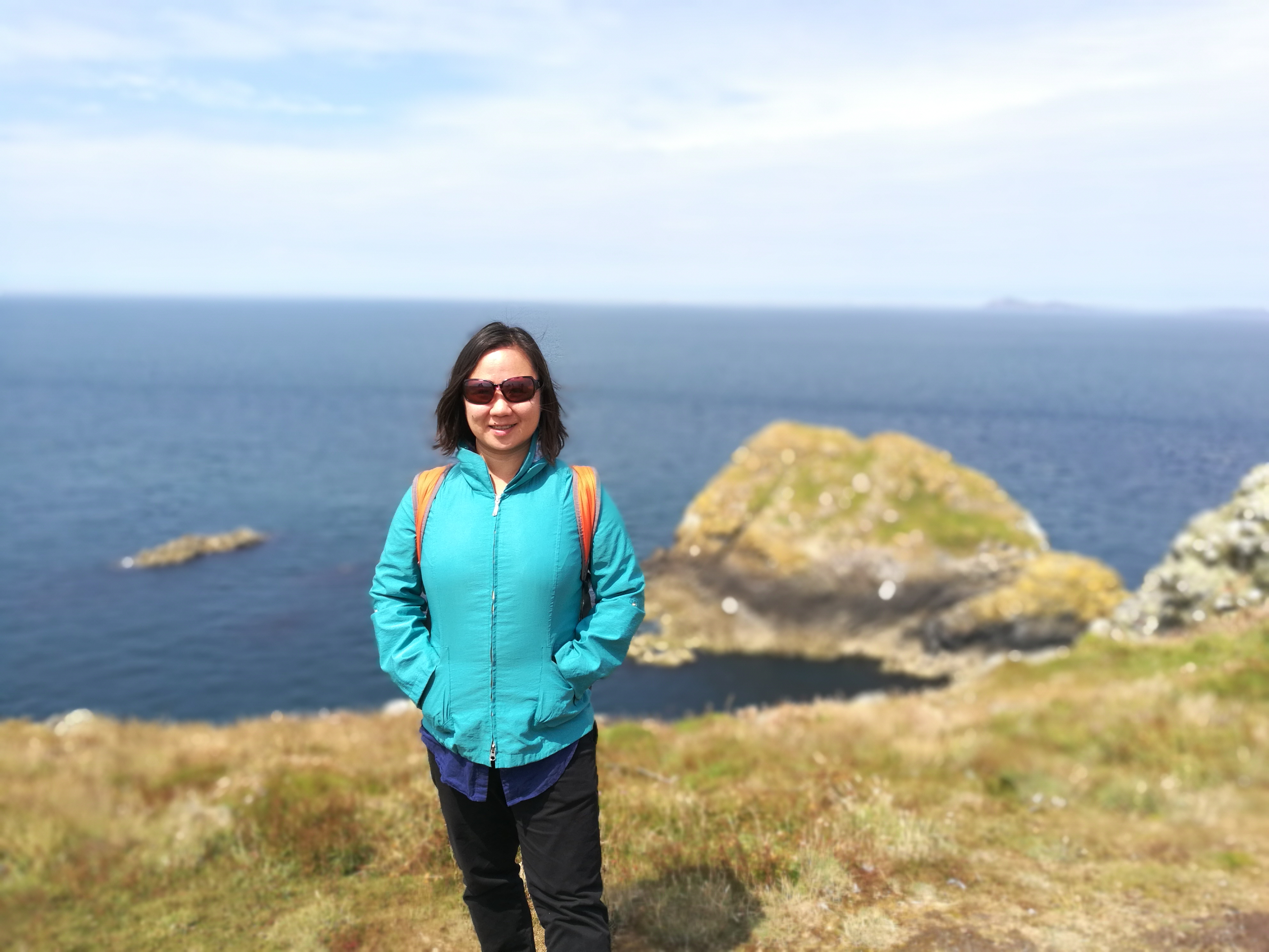 A world traveler with a taste for adventure, Feng poses on Skomer Island, a wildlife refuge in Wales. 