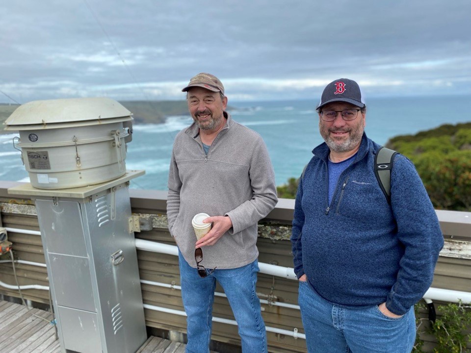 In April 2023, Jay Mace (left) poses at kennaook/Cape Grim, Tasmania, with Roger Marchand. The two were on a site visit for the Cloud And Precipitation Experiment at kennaook (CAPE-k), a field campaign that got underway a year later. Mace and Marchand are co-principal investigators for CAPE-k. 