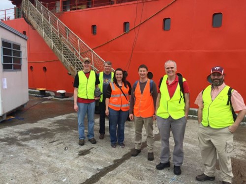 MARCUS principal investigator McFarquhar, second from right, stands dockside of the supply ship Aurora Australis. To his left is MICRE principal investigator Roger Marchand of the University of Washington. 