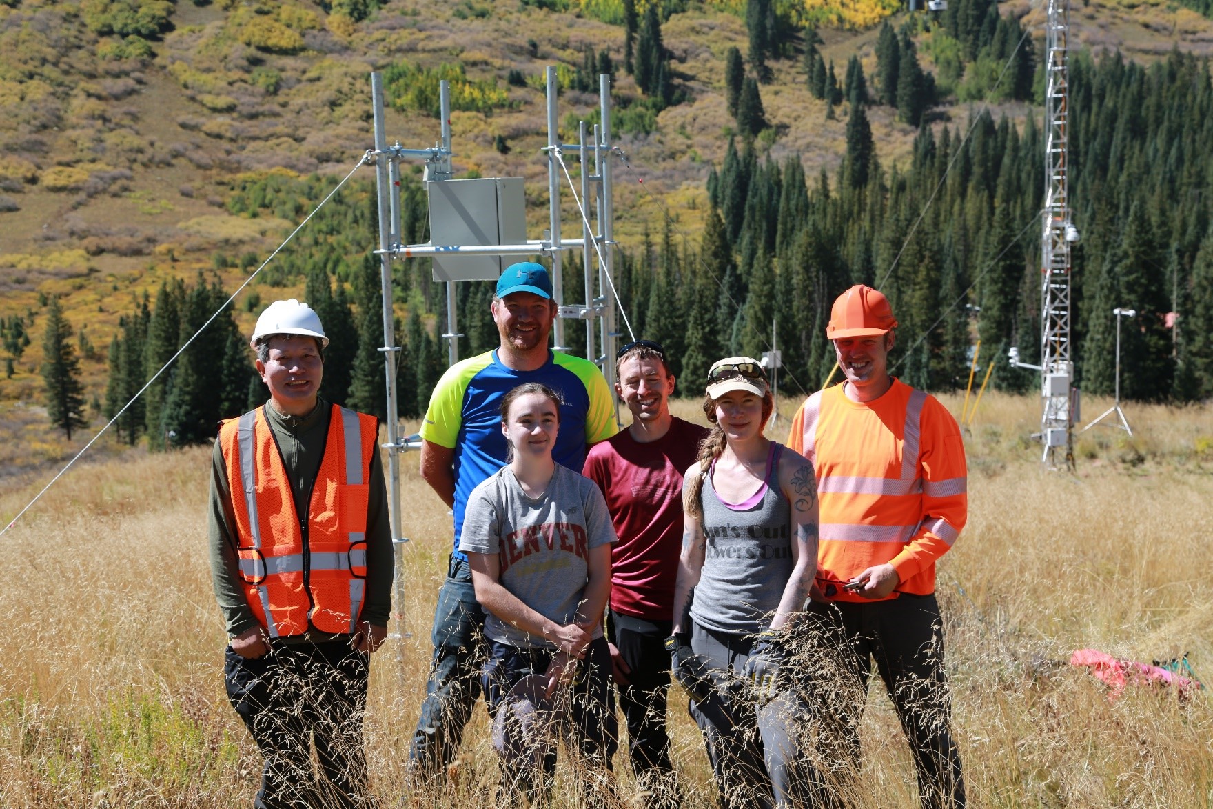 In the fall of 2021, the SAIL-NET group installing aerosol-cloud interaction arrays paused in front of an installation near Gothic Mountain. From left are Ping Chen, Gavin McMeeking, Kate Patterson, Ezra Levin, and Anna Hodshire―all from Handix Scientific. At the far right, in an orange vest, Nick Good of Good Science, LLC. Photo is courtesy of Anna Hodshire.