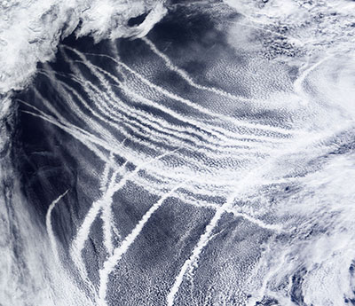 Wood is also interested in ways to make clouds brighter to cool the Earth, including injecting particles into marine clouds. That injection is similar to how the emission of particles by ships into clean air can seed clouds and leave ship tracks like these crisscrossing the Pacific Ocean. 