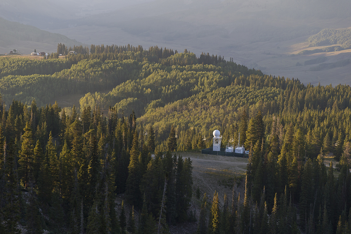 The Colorado State University X-band precipitation radar and ARM Aerosol Observing System are collecting measurements at Crested Butte Mountain Resort as part of SAIL. This view looks northwest at dusk with wildfire smoke wafting into the area.