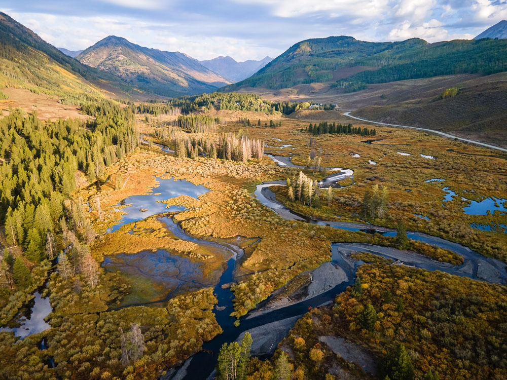 Water is released from mountain snowpack in a variety of ways, including streams that meander (as above, in Colorado’s East River Watershed), those that rush headlong downstream, and in groundwater, which directly contributes to streamflow. Photo is by Snyder.