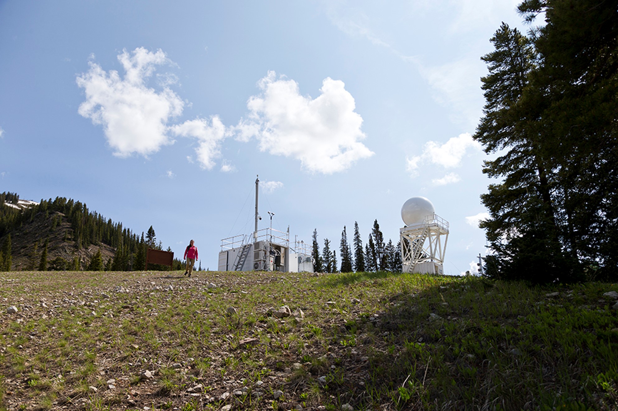 A wisp of clouds above her, Aiken heads back from visiting the ARM Aerosol Observing System and a Colorado State University X-band radar on Crested Butte Mountain. Photo is by Bilow. 