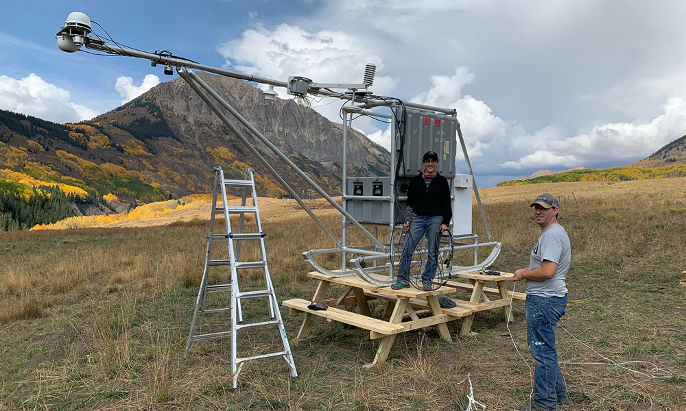 In August 2021, NOAA scientists Janet Intrieri, left, and Christopher Cox helped install a sled-mounted Atmospheric Surface Flux Station south of Gothic. This station is part of the NOAA-led Study of Precipitation, the Lower Atmosphere and Surface for Hydrometeorology (SPLASH). The study started in fall 2021 and is scheduled to run at least through summer 2022. Photo is by Gijs de Boer, Cooperative Institute for Research in Environmental Sciences, NOAA/University of Colorado, Boulder.