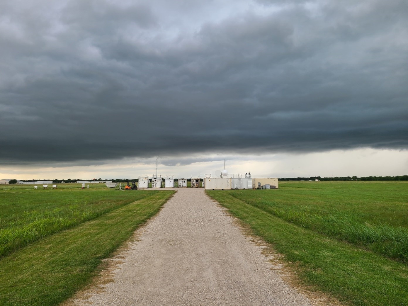 On April 25, 2022, an afternoon storm builds around ARM’s La Porte site. The ARM Mobile Facility is visible at the end of the path. Photo is by Mark Spychala, Hamelmann Communications.