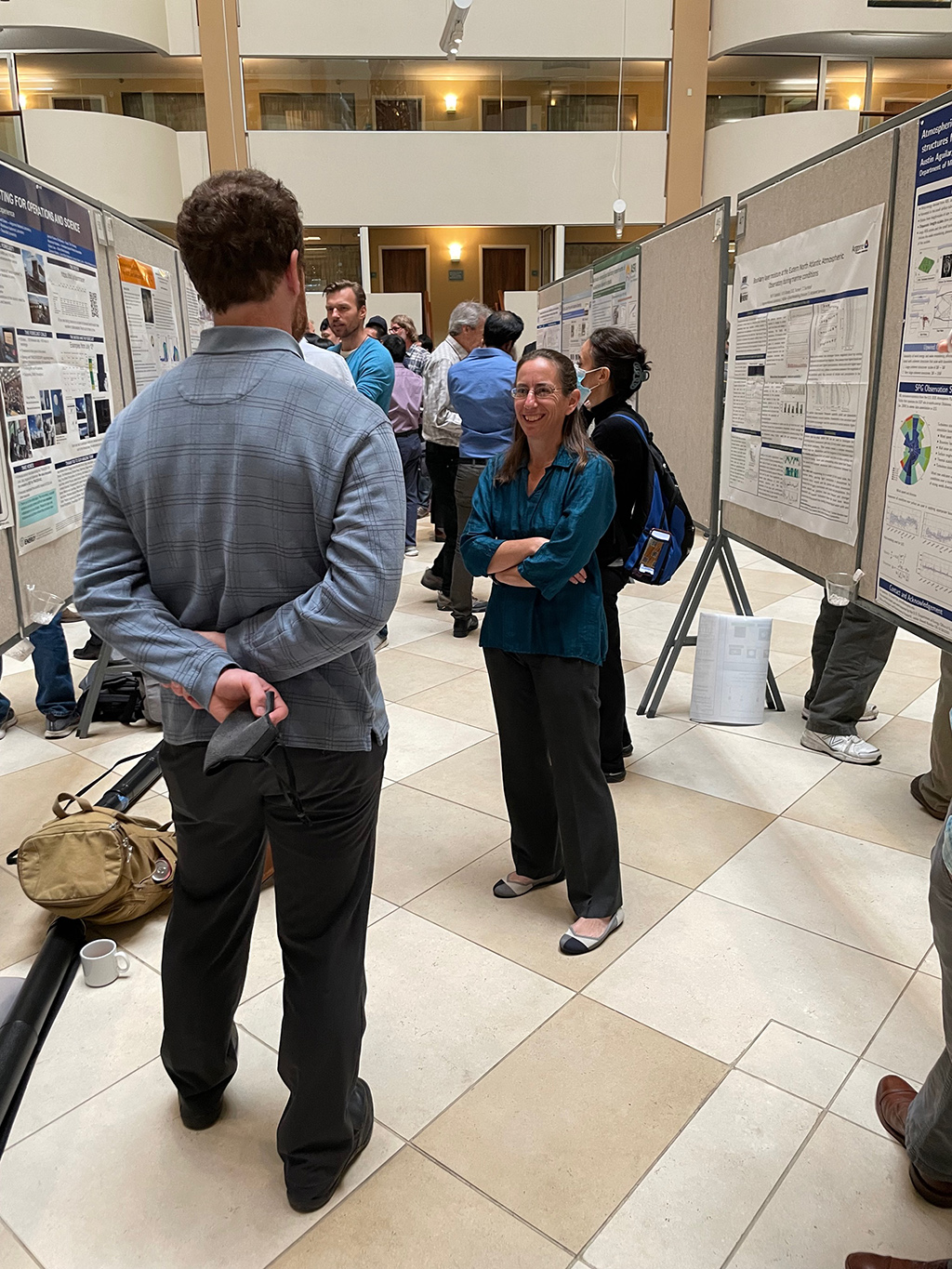 DOE ARM Program Manager Sally McFarlane chats with a poster presenter.